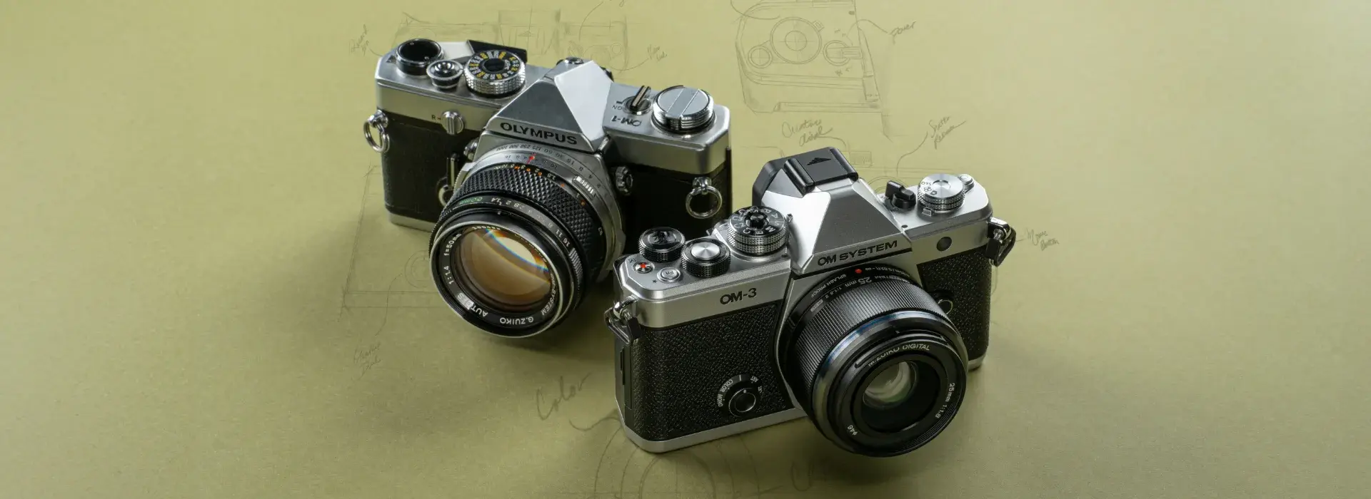Photo of two cameras displaying OM SYSTEM heritage with original OM-1 and new OM-3 next to one another.